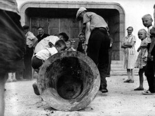 Lifting the bell from the graves to the steps of the church